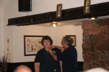 Lion President Twiggy badges up our latest member Karina Wells